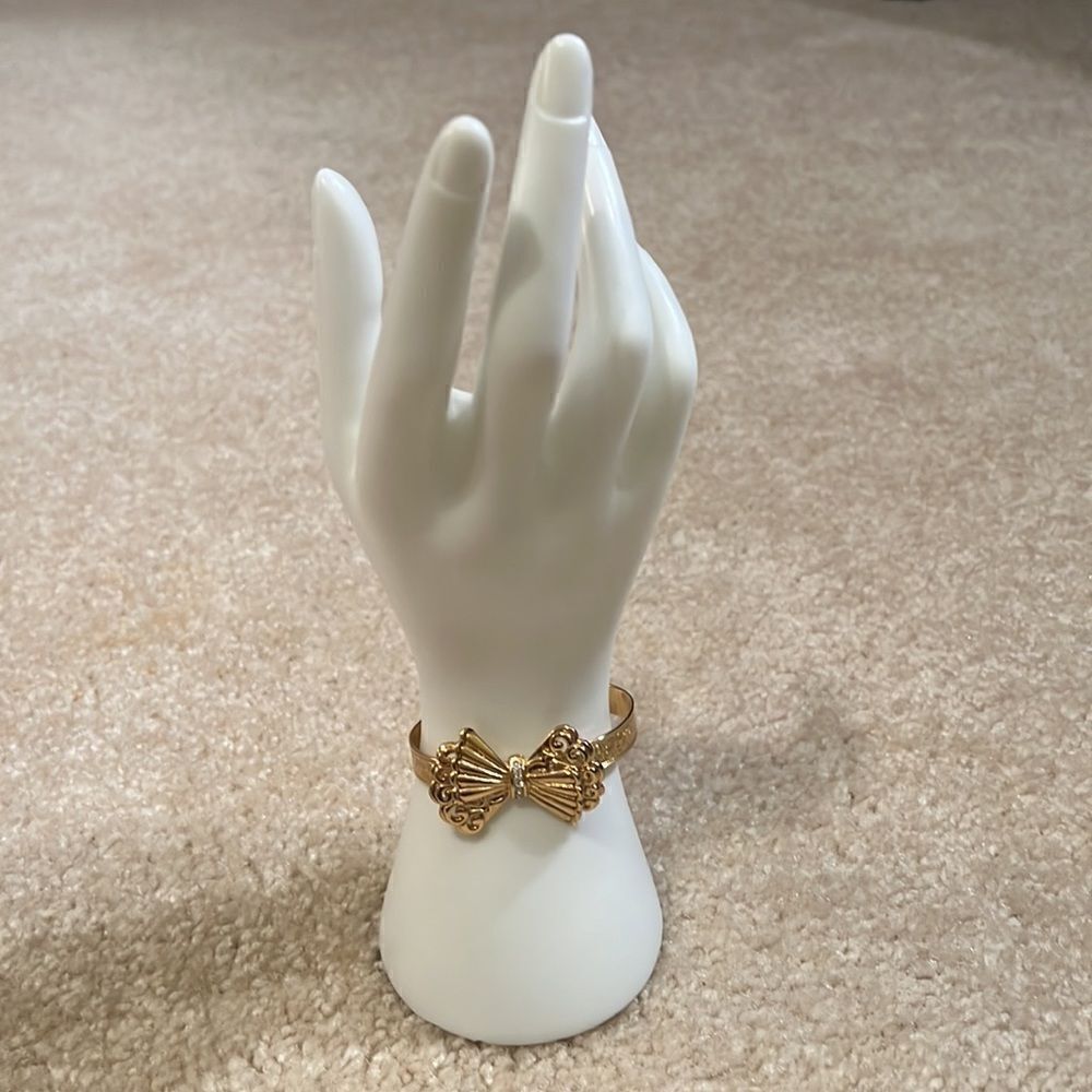 Faux gold/diamond bow bracelet.